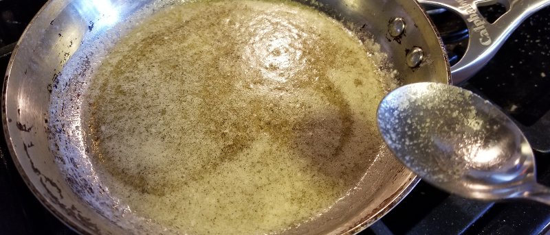 Cannabutter made using decarbed scissor hash that is dissolved into simmering butter.