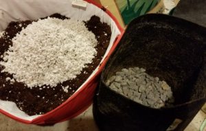 Prepare your coco for your weed clones by adding a layer of rocks for drainage and amending the coco coir with perlite.